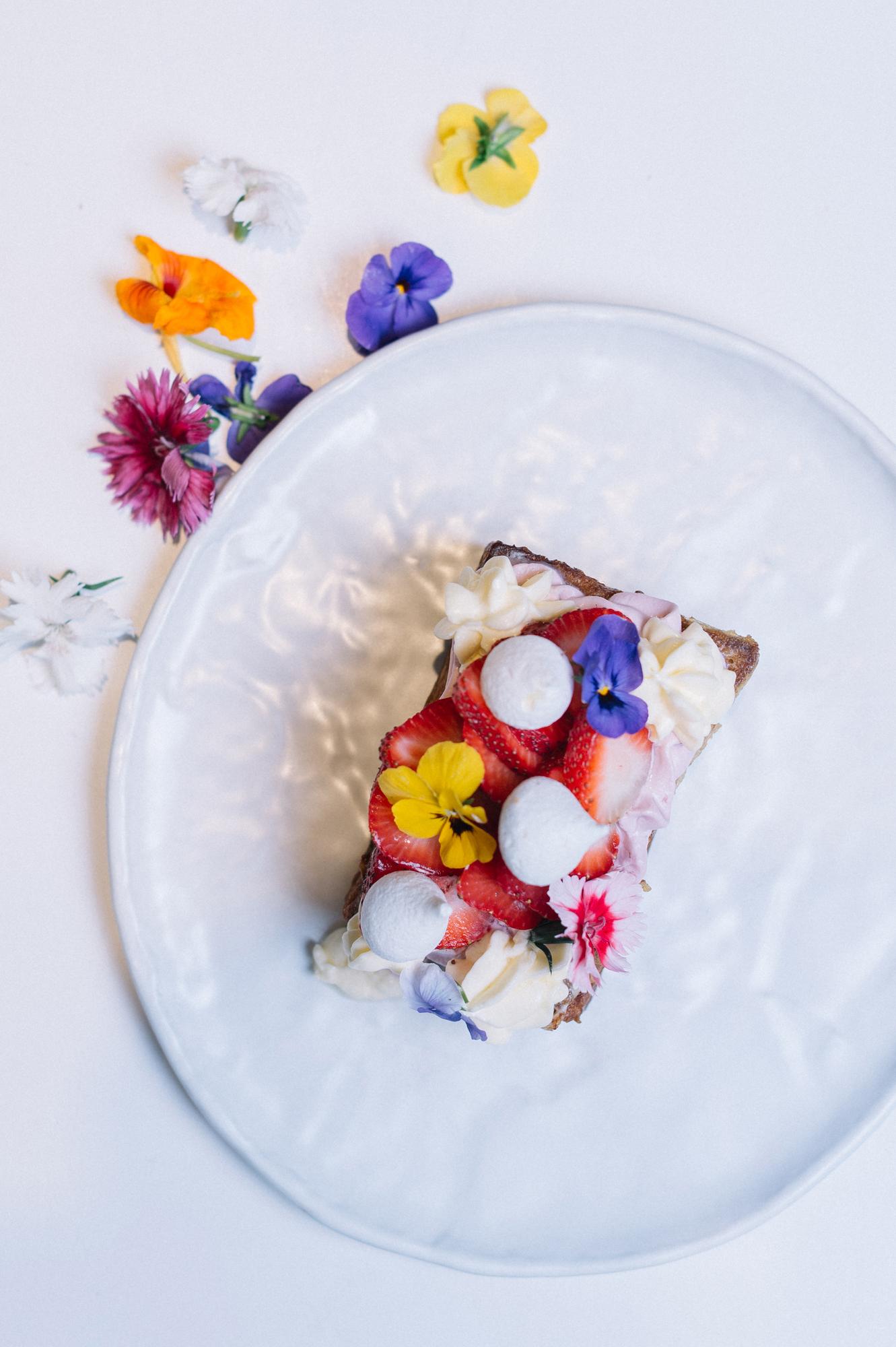 Minimal plated dessert with edible flowers