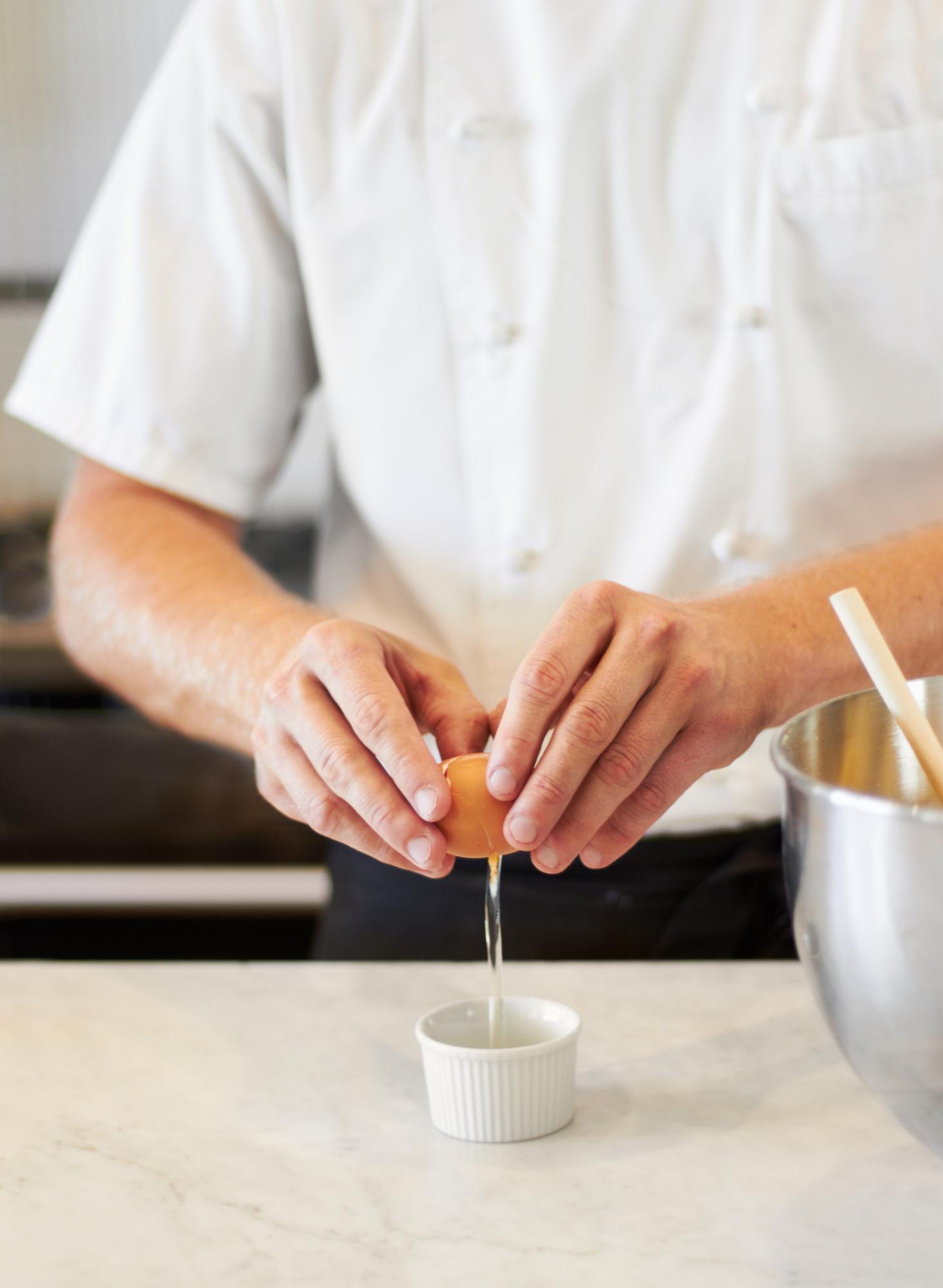 Chef and student tasting a sauce in workshop